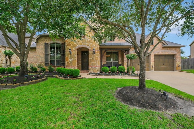 2810 Red Maple Dr, Katy, TX 77494 - view of front facade featuring a front lawn, concrete driveway, brick siding, an attached garage, and stone siding