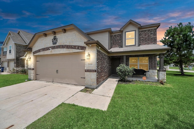 15319 Meandering Post Trl, Houston, TX 77044 - view of front of home with an attached garage, a yard, brick siding, driveway, and stone siding