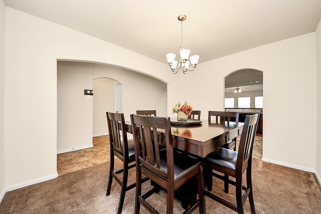 15319 Meandering Post Trl, Houston, TX 77044 - carpeted dining area featuring arched walkways, a chandelier, and baseboards