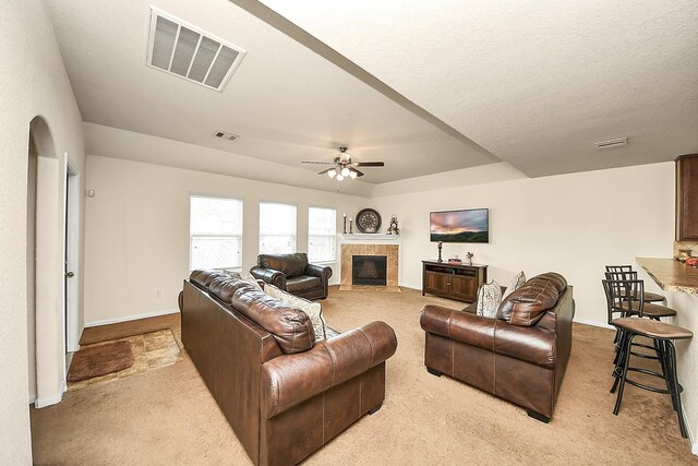 15319 Meandering Post Trl, Houston, TX 77044 - carpeted living area featuring a ceiling fan, a glass covered fireplace, and baseboards