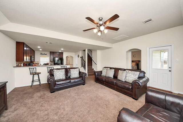 15319 Meandering Post Trl, Houston, TX 77044 - living area with arched walkways, a ceiling fan, carpet, stairway, and recessed lighting