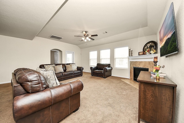 15319 Meandering Post Trl, Houston, TX 77044 - living room with arched walkways, carpet floors, ceiling fan, and a fireplace