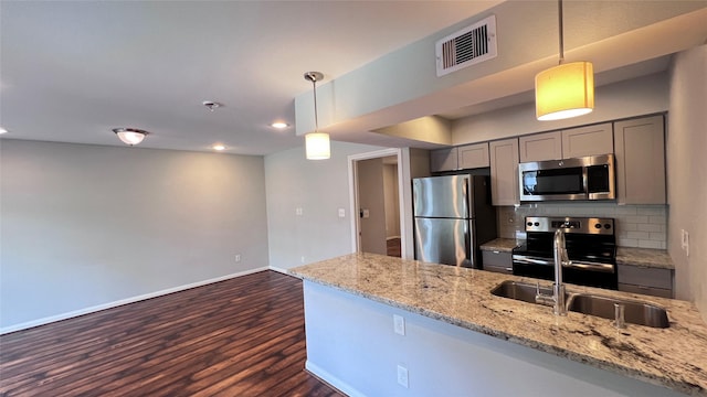 5333 Richmond Ave Unit 16, Houston, TX 77056 - kitchen featuring appliances with stainless steel finishes, gray cabinets, dark wood finished floors, light stone countertops, and baseboards