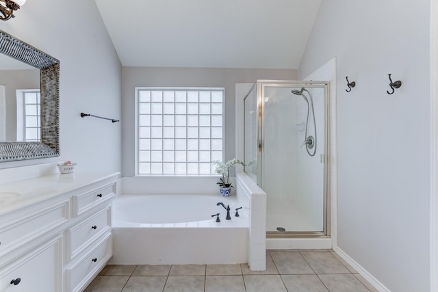 8226 Broken Timber Way, Houston, TX 77095 - full bathroom with tile patterned floors, vaulted ceiling, a shower stall, a garden tub, and vanity