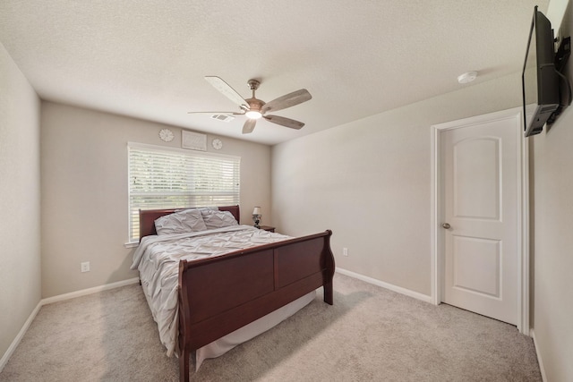 26410 Yaupon Crk, Magnolia, TX 77355 - bedroom with light colored carpet, ceiling fan, baseboards, and a textured ceiling