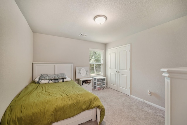 26410 Yaupon Crk, Magnolia, TX 77355 - bedroom featuring carpet, a textured ceiling, a closet, and baseboards