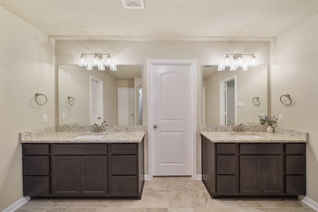26410 Yaupon Crk, Magnolia, TX 77355 - bathroom with two vanities and baseboards
