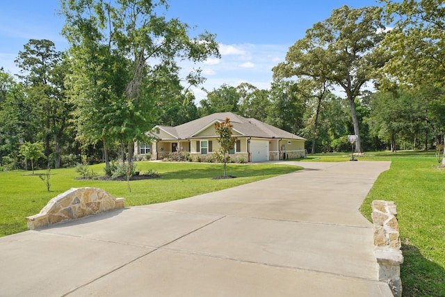 26410 Yaupon Crk, Magnolia, TX 77355 - view of front of house featuring concrete driveway, a front lawn, a garage, and view of scattered trees