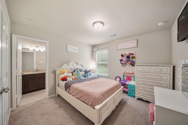 26410 Yaupon Crk, Magnolia, TX 77355 - bedroom with light colored carpet, a textured ceiling, and ensuite bathroom