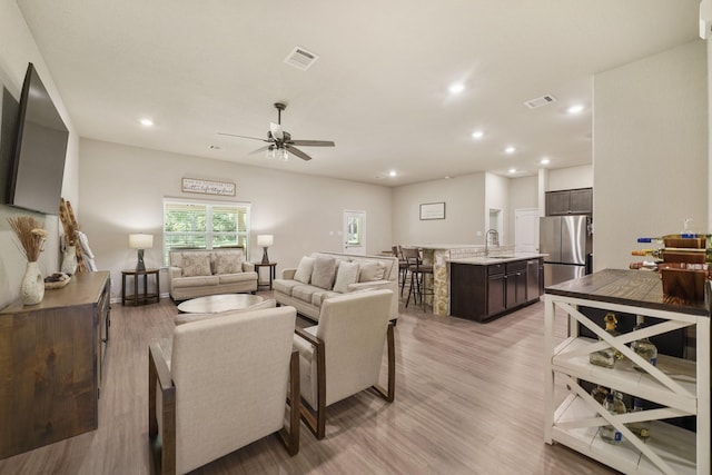 26410 Yaupon Crk, Magnolia, TX 77355 - living room featuring light wood finished floors, recessed lighting, and a ceiling fan