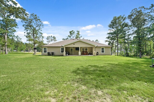 26410 Yaupon Crk, Magnolia, TX 77355 - rear view of house with a yard