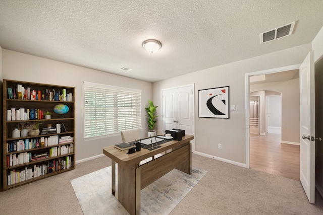 26410 Yaupon Crk, Magnolia, TX 77355 - office with arched walkways, light carpet, a textured ceiling, and baseboards