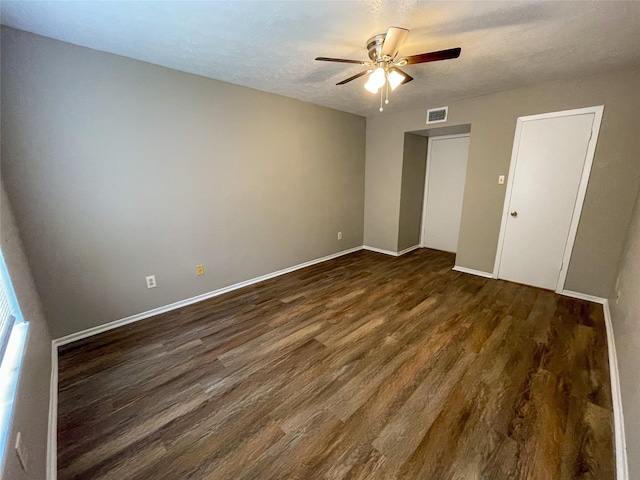 10555 Turtlewood Ct Unit 610, Houston, TX 77072 - spare room featuring dark wood-type flooring, a ceiling fan, and baseboards