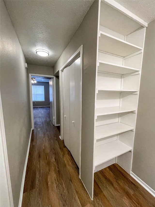 10555 Turtlewood Ct Unit 610, Houston, TX 77072 - corridor with a textured ceiling, wood finished floors, and baseboards