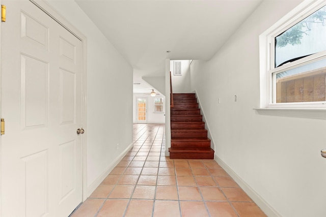 4015 Garrott St, Houston, TX 77006 - stairs featuring tile patterned flooring, baseboards, and a ceiling fan