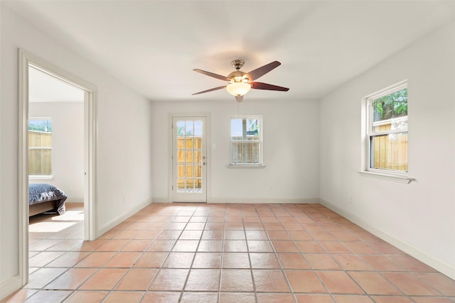 4015 Garrott St, Houston, TX 77006 - empty room featuring light tile patterned flooring, ceiling fan, and baseboards