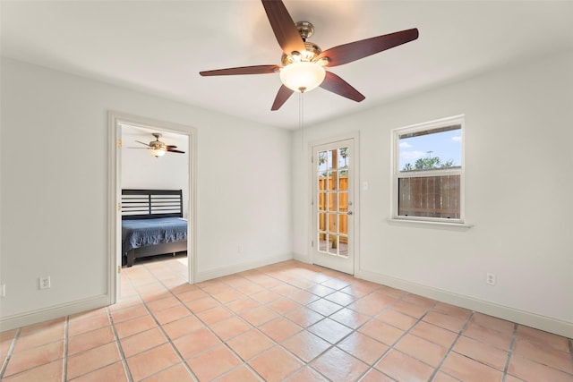4015 Garrott St, Houston, TX 77006 - spare room with ceiling fan, light tile patterned flooring, and baseboards