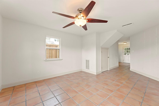 4015 Garrott St, Houston, TX 77006 - unfurnished room featuring ceiling fan, light tile patterned floors, and baseboards