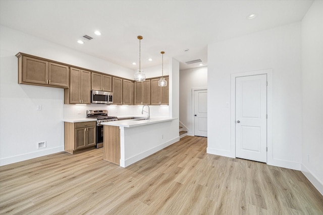 1544 W Tidwell Rd, Houston, TX 77091 - kitchen featuring appliances with stainless steel finishes, light wood finished floors, light countertops, a sink, and recessed lighting