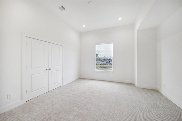 1544 W Tidwell Rd, Houston, TX 77091 - unfurnished bedroom featuring light colored carpet, baseboards, recessed lighting, and a closet