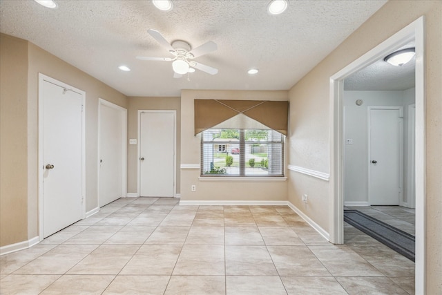 1018 W Castlewood Ave, Friendswood, TX 77546 - entryway with a textured ceiling, ceiling fan, recessed lighting, light tile patterned flooring, and baseboards