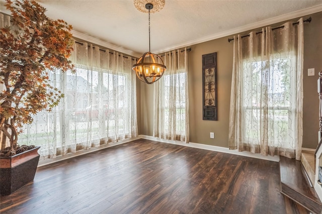 1914 Tipperary Dr, Deer Park, TX 77536 - unfurnished dining area with a chandelier, wood finished floors, healthy amount of natural light, a textured ceiling, and crown molding