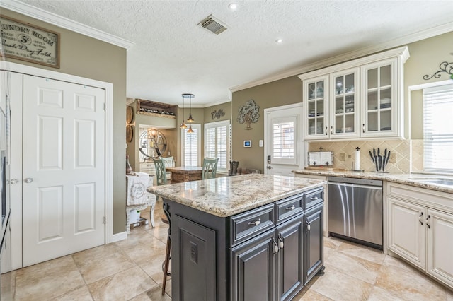 1914 Tipperary Dr, Deer Park, TX 77536 - kitchen with dishwasher, decorative backsplash, glass insert cabinets, a kitchen island, and decorative light fixtures