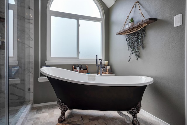 1914 Tipperary Dr, Deer Park, TX 77536 - bathroom featuring a stall shower, a freestanding tub, and baseboards