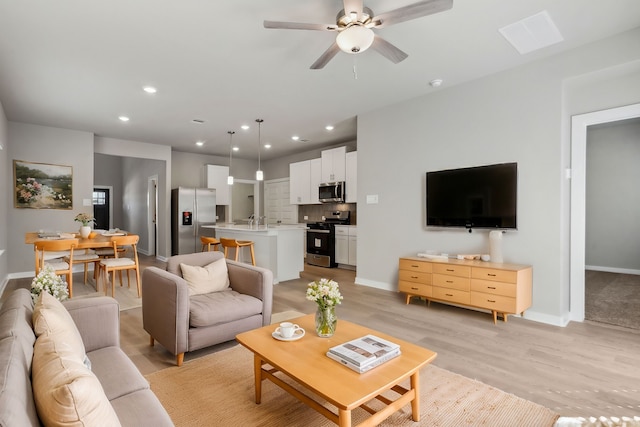 18737 Bliss Pl, New Caney, TX 77357 - living room with baseboards, light wood-style floors, ceiling fan, and recessed lighting