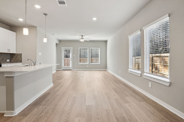 18737 Bliss Pl, New Caney, TX 77357 - unfurnished living room featuring a sink, plenty of natural light, a ceiling fan, light wood-style flooring, and recessed lighting