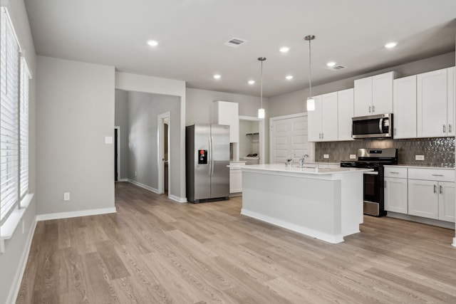 18737 Bliss Pl, New Caney, TX 77357 - kitchen featuring stainless steel appliances, backsplash, light wood-style flooring, light countertops, and recessed lighting