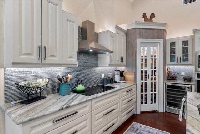 181 Saint Andrews Dr, Mabank, TX 75156 - kitchen with wall chimney exhaust hood, wine cooler, black electric stovetop, backsplash, and dark wood-style flooring