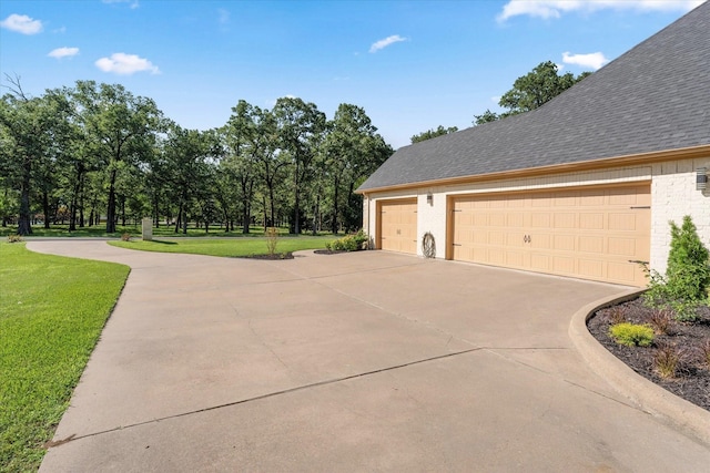 181 Saint Andrews Dr, Mabank, TX 75156 - view of side of home with a garage, a yard, a shingled roof, concrete driveway, and brick siding
