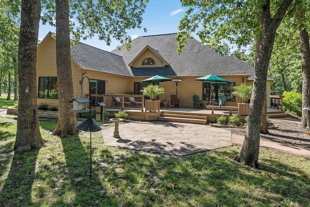 181 Saint Andrews Dr, Mabank, TX 75156 - rear view of property with a patio area, a wooden deck, and roof with shingles