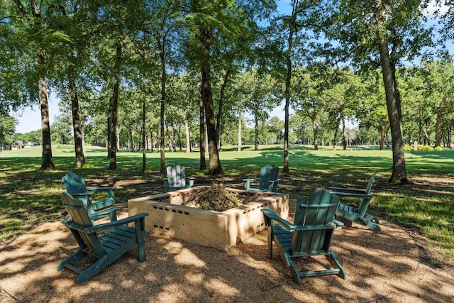 181 Saint Andrews Dr, Mabank, TX 75156 - view of property's community with an outdoor fire pit, view of scattered trees, and a lawn