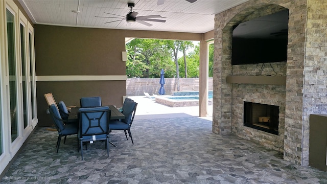 807 Steele Rd Unit A, Highlands, TX 77562 - view of patio with an outdoor stone fireplace and a ceiling fan