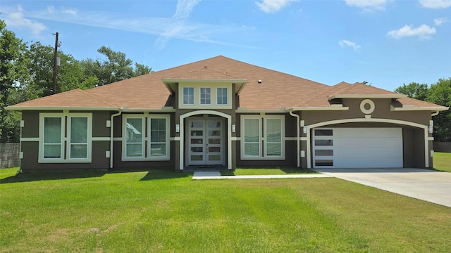 807 Steele Rd Unit A, Highlands, TX 77562 - view of front of home featuring stucco siding, driveway, a front yard, an attached garage, and roof with shingles