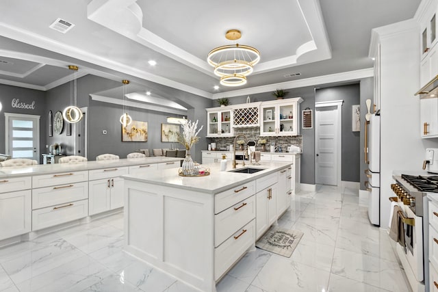 807 Steele Rd Unit A, Highlands, TX 77562 - kitchen with high end white range, light marble finish floors, a sink, a kitchen island with sink, and ornamental molding