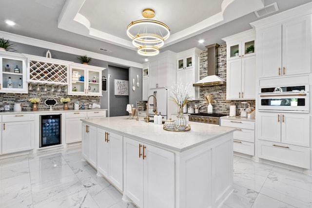 807 Steele Rd Unit A, Highlands, TX 77562 - kitchen featuring beverage cooler, light marble finish floors, backsplash, white cabinets, and recessed lighting