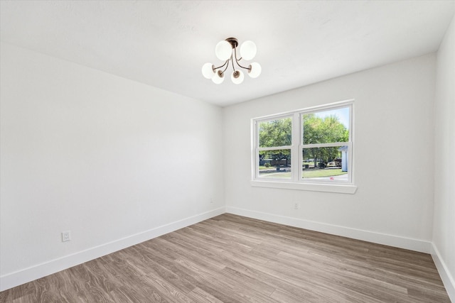 10830 Bob White Dr, Houston, TX 77096 - empty room with a chandelier, baseboards, and light wood-style flooring