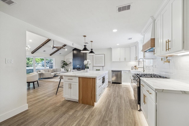 10830 Bob White Dr, Houston, TX 77096 - kitchen featuring stainless steel appliances, open floor plan, light wood finished floors, tasteful backsplash, and recessed lighting