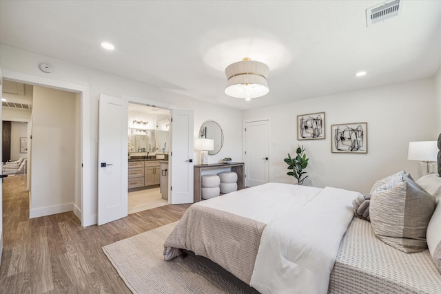10830 Bob White Dr, Houston, TX 77096 - bedroom with light wood-style floors, recessed lighting, baseboards, and connected bathroom