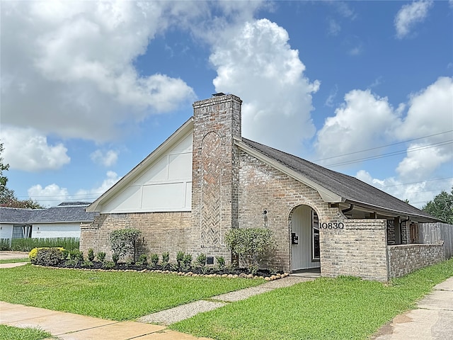 10830 Bob White Dr, Houston, TX 77096 - view of side of home with brick siding and a chimney