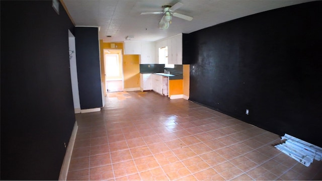 4145 Chaison St, Beaumont, TX 77705 - unfurnished living room featuring a ceiling fan, baseboards, and tile patterned flooring
