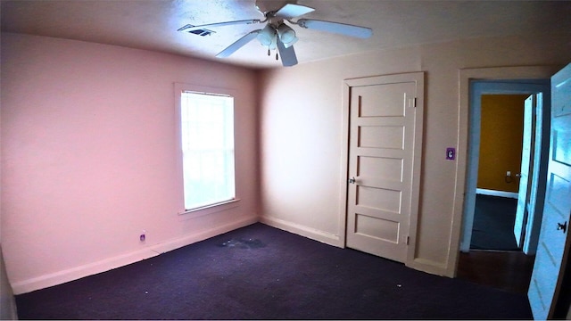 4145 Chaison St, Beaumont, TX 77705 - unfurnished bedroom with dark carpet, baseboards, and a ceiling fan