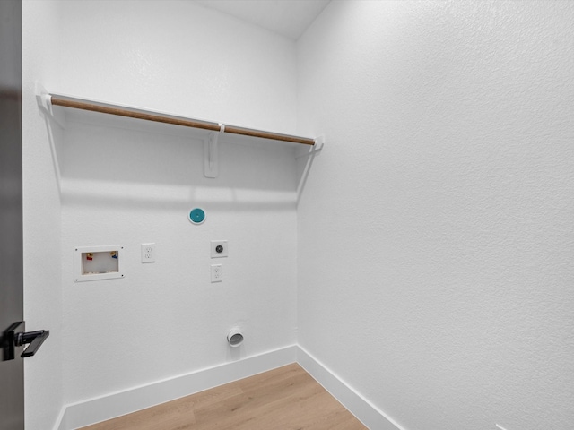 10732 Twin Oaks Dr, Conroe, TX 77385 - laundry room with hookup for an electric dryer, washer hookup, hookup for a gas dryer, light wood-style floors, and baseboards