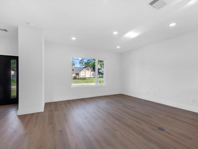 10732 Twin Oaks Dr, Conroe, TX 77385 - empty room with plenty of natural light, wood finished floors, baseboards, recessed lighting, and a smoke detector