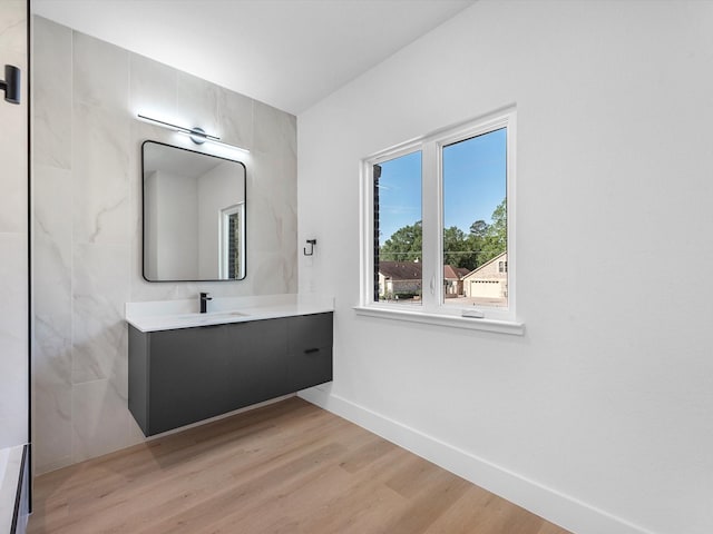 10732 Twin Oaks Dr, Conroe, TX 77385 - bathroom featuring vanity, wood finished floors, and baseboards