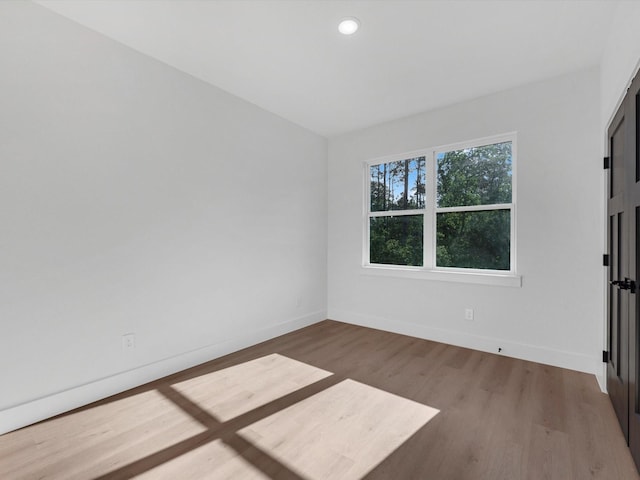 10732 Twin Oaks Dr, Conroe, TX 77385 - spare room with wood finished floors, baseboards, and recessed lighting