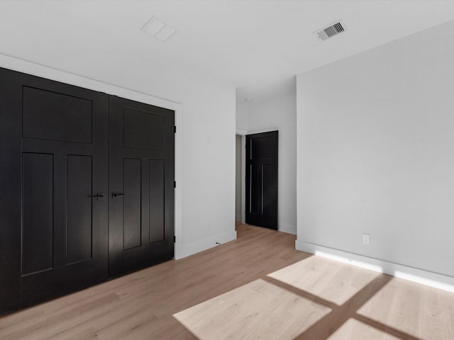 10732 Twin Oaks Dr, Conroe, TX 77385 - unfurnished bedroom featuring a closet, light wood-type flooring, and baseboards
